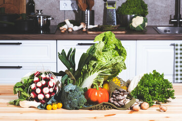 Fresh vegetables and herbs arranged in an eco-friendly bag on a kitchen table, ready for healthy...