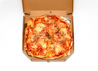 Baked pizza inside open cardboard delivery box
