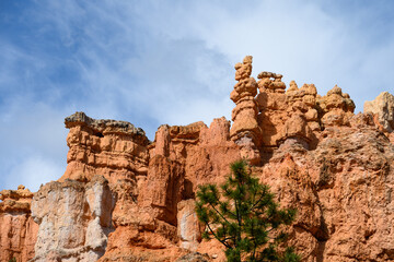 Looking up from base of the amphitheater on queens trail at dramatic orange rock hoodoos, summer vacation exploring in Bryce Canyon National Park, Utah
