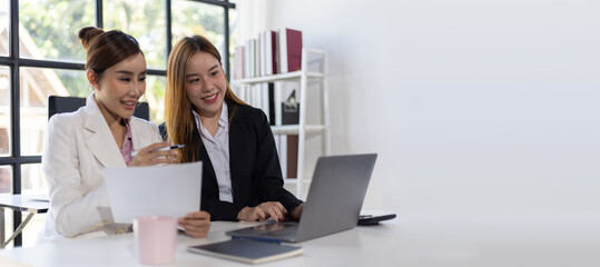 Woman office worker discussing new project with colleague during working day in coworking. Businesswoman working with colleagues in the office.