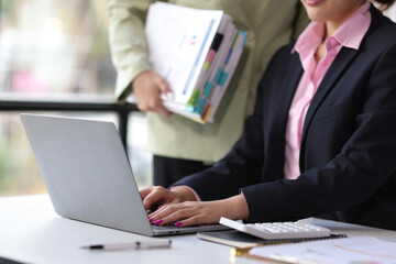 Business woman is discussing business situation analysis and financial planning with colleagues.