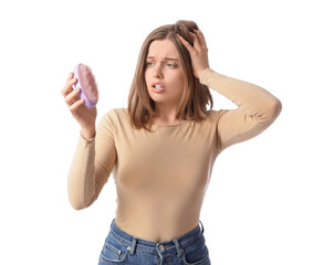 Worried young woman with hair loss problem and brush on white background