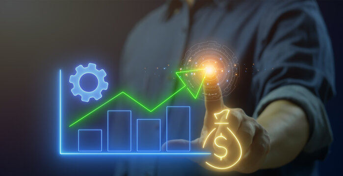 Business efficiency concept, how much a company or organization can produce as it relates to time, cost and quality. Businessman shows glowing neon line of profit maximization icon on virtual screen. - Powered by Adobe