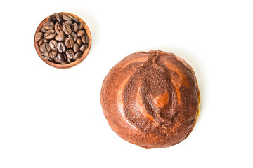 Top view of coffee bun with roasted coffee beans in the little wooden bowl isolated on white background. Coffee bun bread home made. Mexican Coffee Bun. close up, high angle, above, clipping path.