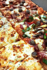 Close-up of Sliced Pizza with Various Toppings
