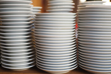 Stacked plates ready for serving in a busy kitchen