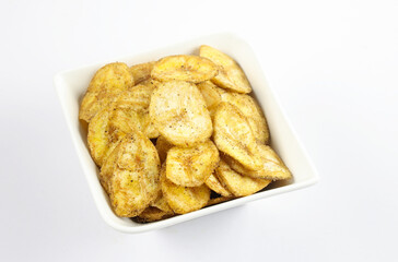 Indian homemade crispy snacks called banana chips serve in bowl isolated on white background 