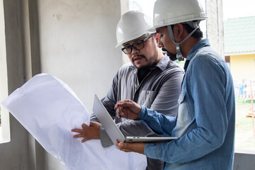 Hispanic engineer man with mustache wearing safety white helmet consult team project manager...