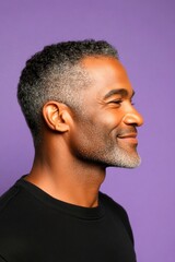 An expressive midlife man with a fashionable style. A trendy and poised male showing charm. A handsome man in his 40s with a radiant smile. A studio glamour portrait of a confident man.