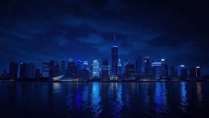 Obraz premium Night cityscape with illuminated skyscrapers reflecting in the dark water, under a cloudy sky.