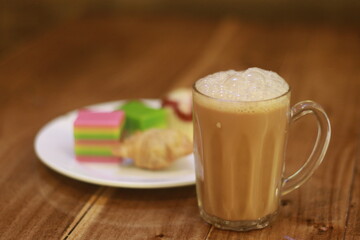 A glass of milk tea drink with foam