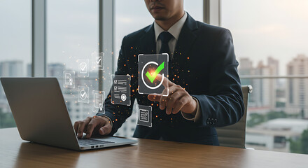 Businessman interacting with digital compliance icons while using a laptop in an office setting
