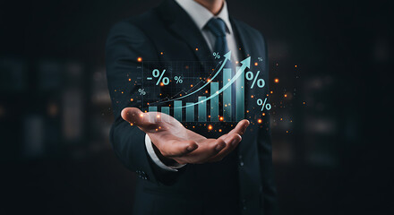 Businessman holding a rising bar graph with percentage symbols in his open hand on a dark background