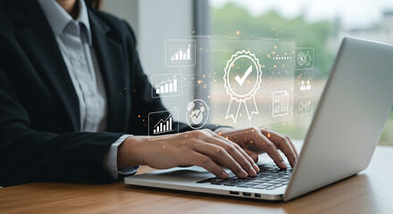 Businesswoman typing on laptop with quality assurance and data analysis icons overlayed on screen