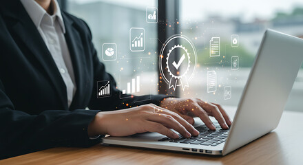 Businesswoman typing on laptop with data analytics and quality assurance icons overlaying the screen