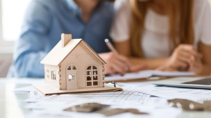 Couple reviewing property listings and financial documents for a home purchase.