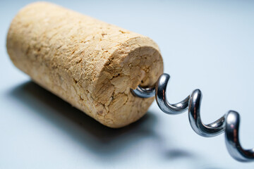 Metal corkscrew inserted into a wine cork, ready to open a bottle