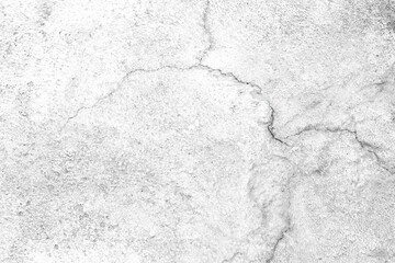 White concrete wall exhibiting rough textured surface with cracks. Cracked concrete surface...