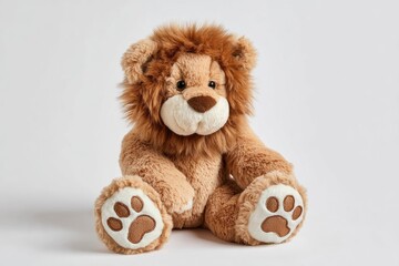 Obraz premium A tan stuffed lion sits centered facing forward with detailed paws and a fluffy mane
