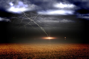Stormy sky over field with lightning
