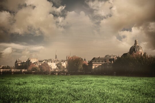 Fototapeta Flat design is showing large classical domed building rising over green grass field and cloudy sky