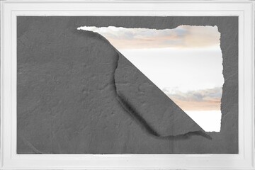 Rip on wall showing bright sky