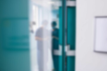 Two surgeons interacting with each other in corridor