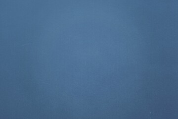 Uniform blue textured surface is filling full frame in flat design and creating abstract backdrop