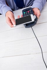 Man using smartphone to express pay