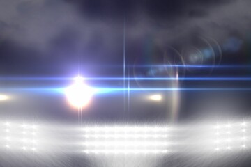 Bright stadium floodlights are shining lens flare beams over misty grass field in flat design