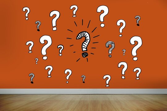 Question marks on orange wall