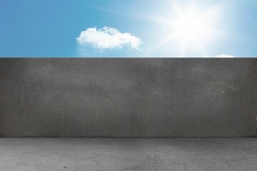 Flat design showing grey concrete barrier wall on concrete ground, with blue sky and small cloud