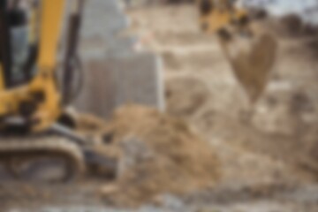 Bulldozer moving heap of mud at construction site