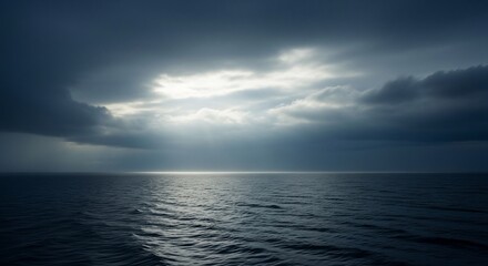 Obraz premium Sea illuminated by opening storm clouds