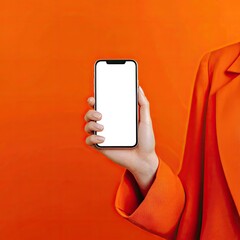 Hand holding a phone against an orange background