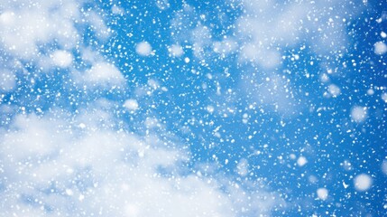 Obraz premium Vivid blue sky speckled with falling snow and fluffy clouds