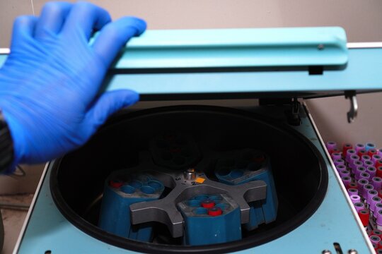 Laboratory equipment centrifuge in hospital or clinic. Blue medical centrifuge with blood tube.Device for laboratory research.Modern lab technology. - Powered by Adobe