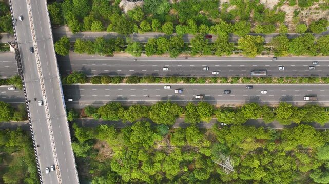 Top-down aerial shot showing a single car driving along an empty desert road.