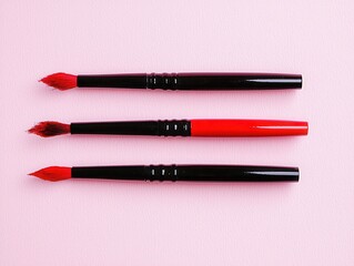 Selection of Red Brushes on Soft Pink Background for Art and Craft Projects