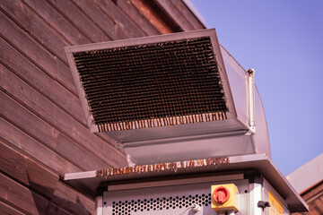Greasy and dirty exhaust grille outdoors on a ventilation system — close-up detail. 
