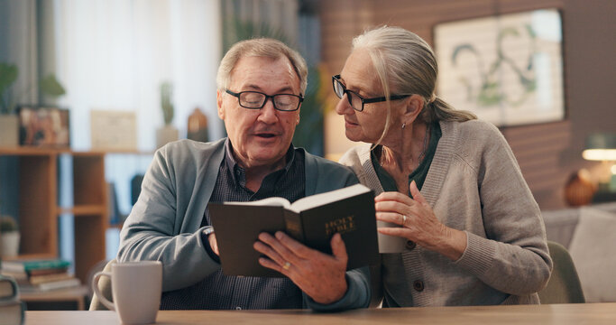 Senior couple, bible and reading in home for faith, study or coffee with spiritual scripture in lounge. Old man, woman and book for learning with Christianity, religion or tea in house for retirement