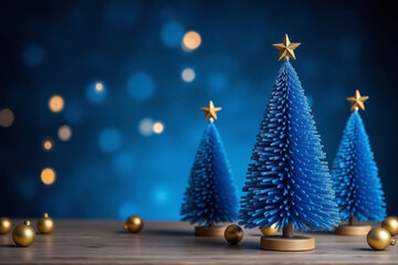 three blue christmas trees with gold stars on a blue background