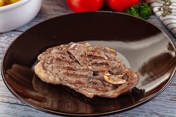 Grilled lamb steak with bone