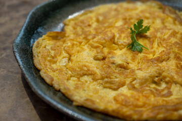 Close-up photo of Omelet served with coriander on the top