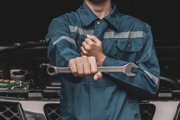 Auto mechanic with wrench in auto repair shop
