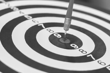 Darts arrows hitting the center of dartboard, business success concept