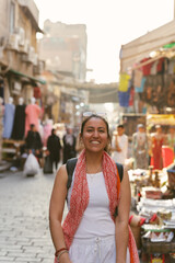 Tourist smiling and walking in a traditional market in cairo, egypt