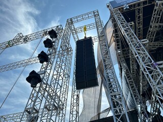 Installation of professional sound speakers, line array and stage equipment for a concert.