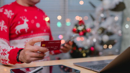 Cozy Christmas Online Shopping Festive Holiday Attire And Credit Card On Wooden Desk With Tablet, Bathed In Warm Light, For Convenient Online Holiday Payments