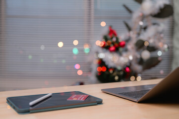 Christmas, Warm, Festive Holiday Scene Featuring Tablet And Stylus, Ready For An Online Transaction, Illuminated By Soft Window Light, Perfect For Cozy Remote Work
